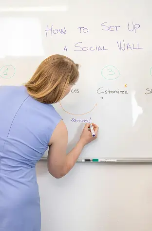 Alchemy coach teaching a live office hours session at a whiteboard